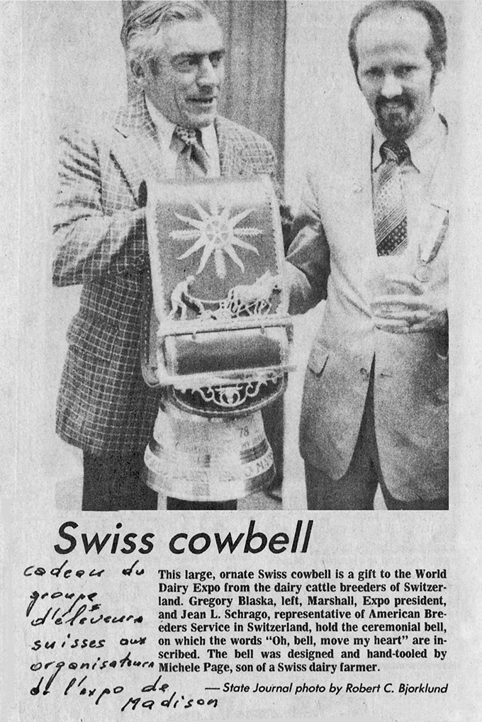 This large, ornate Swiss cowbell Is a gift to the World Dairy Expo from the dairy cattle breeders of Switzerland. Gregory Blaska, left, Marshall, Expo president, and Jean L. Schrago, representative of American Breeders Service in Switzerland, hold the ceremonial bell, on which the words “0h, bell, move my heart” are inscribed. The bell was designed and hand-tooled by Michele Page, son of a Swiss dairy farmer. — State Journal photo by Robert C. Bjorklund